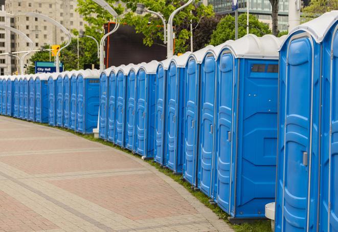 a row of portable restrooms set up for a large athletic event, allowing participants and spectators to easily take care of their needs in Boerne TX